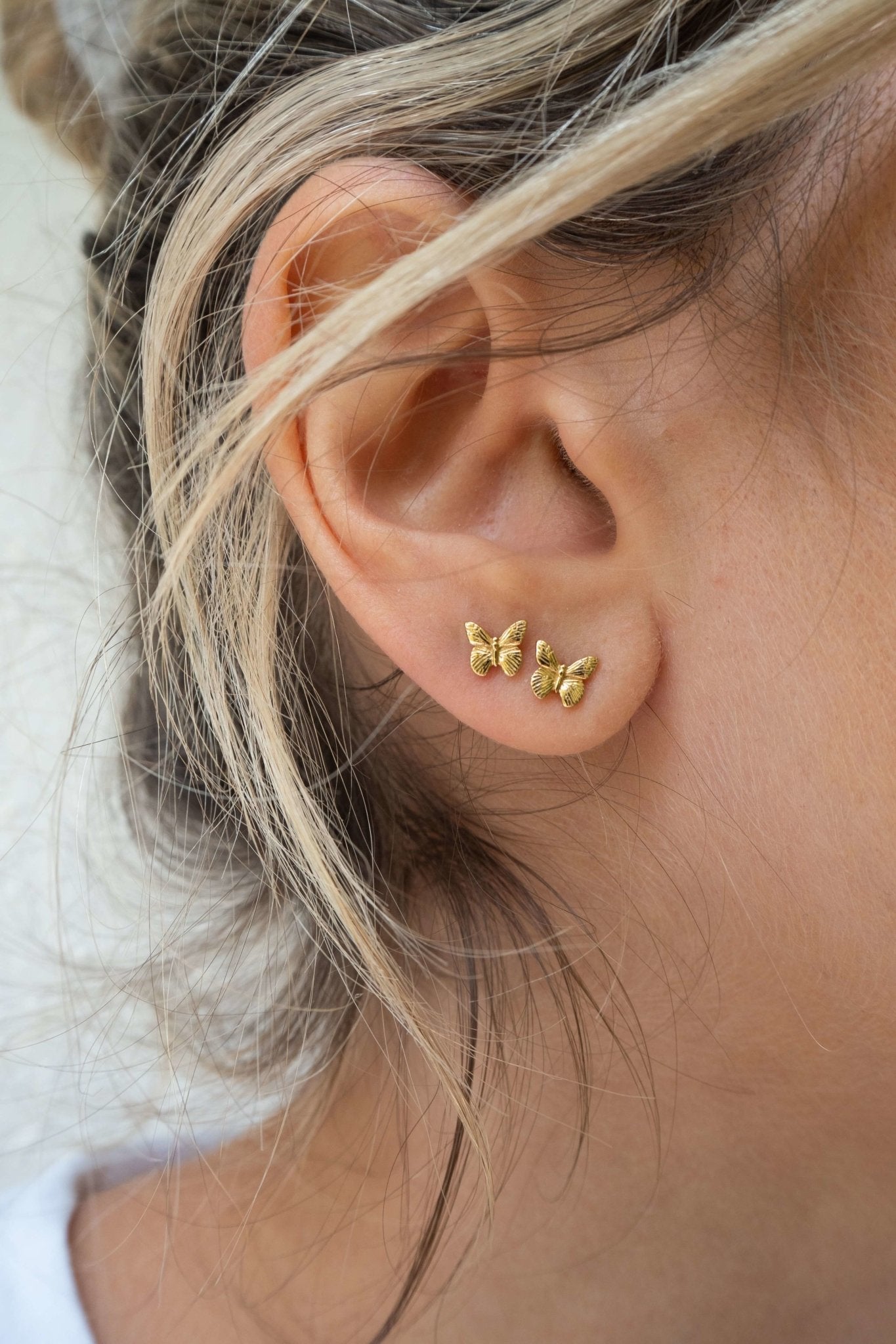 Tiny gold water proof butterfly earring studs